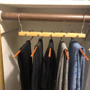 reviewer photo showing five pairs of pants on the hanger