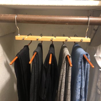 reviewer photo showing five pairs of pants on the hanger