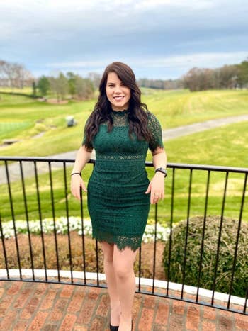 Reviewer wearing the dress in green