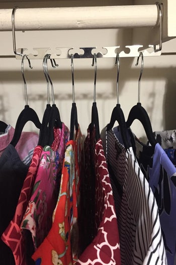 reviewer photo showing seven shirts hanging on their closet rack 