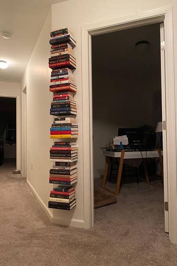 reviewer photo showing a stack of floating book shelves filled with several books 