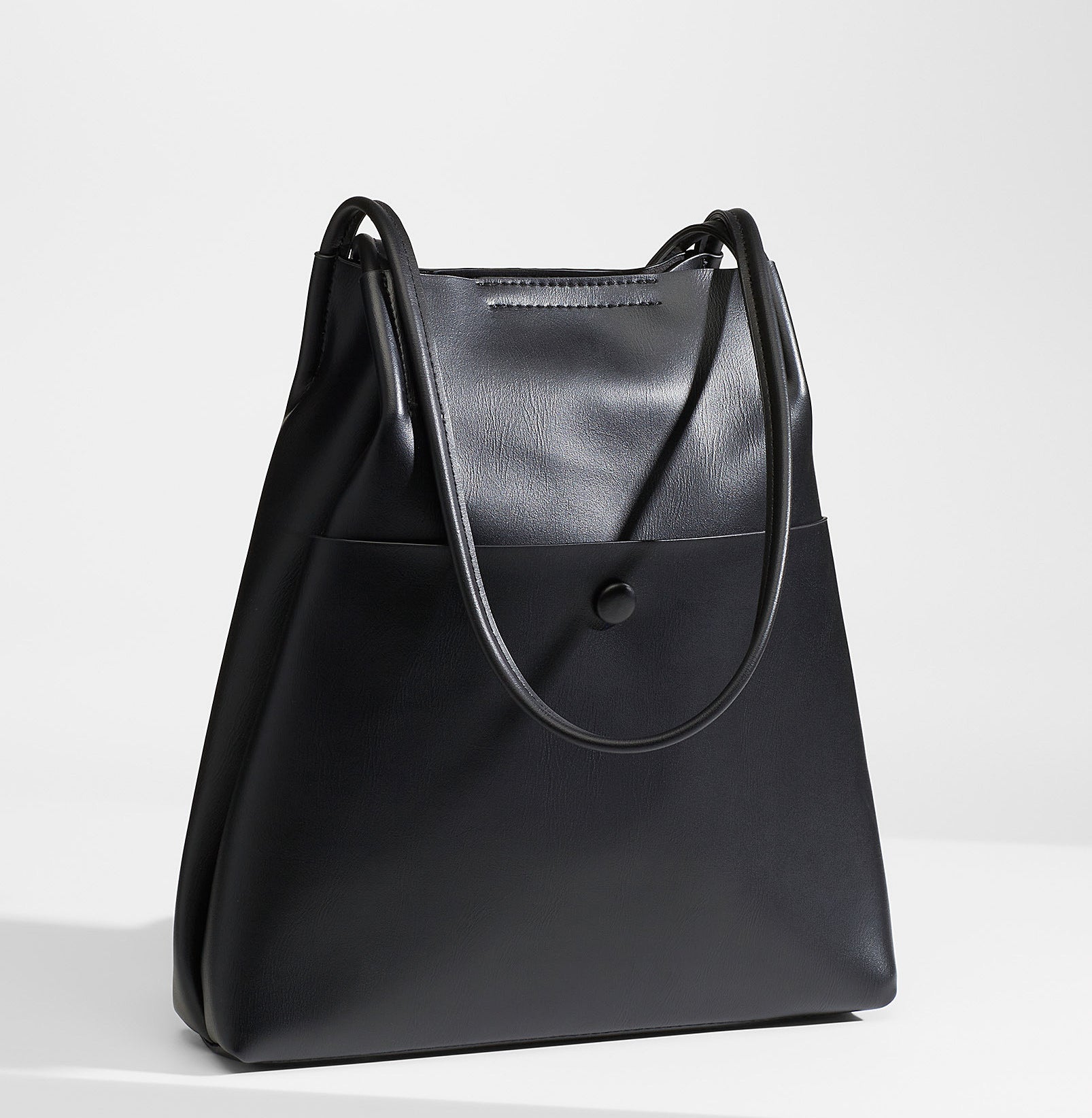 A large faux leather bag with thin long straps