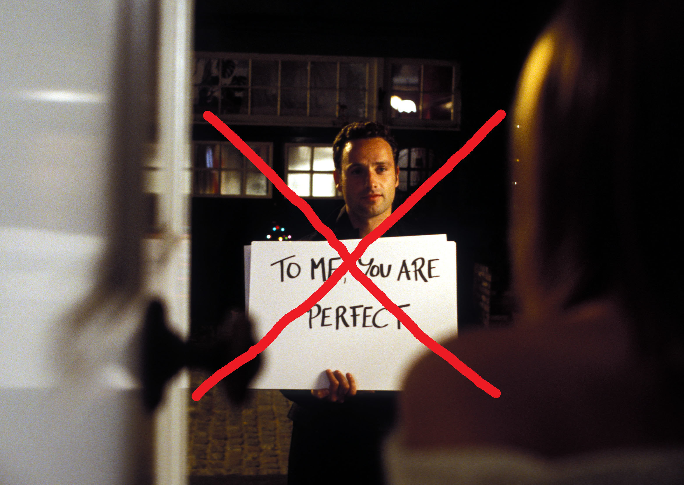 A crossed-out image of the scene where Andrew Lincoln holds up a card that says &quot;To me, &quot;You are perfect&quot; for Keira Knightly