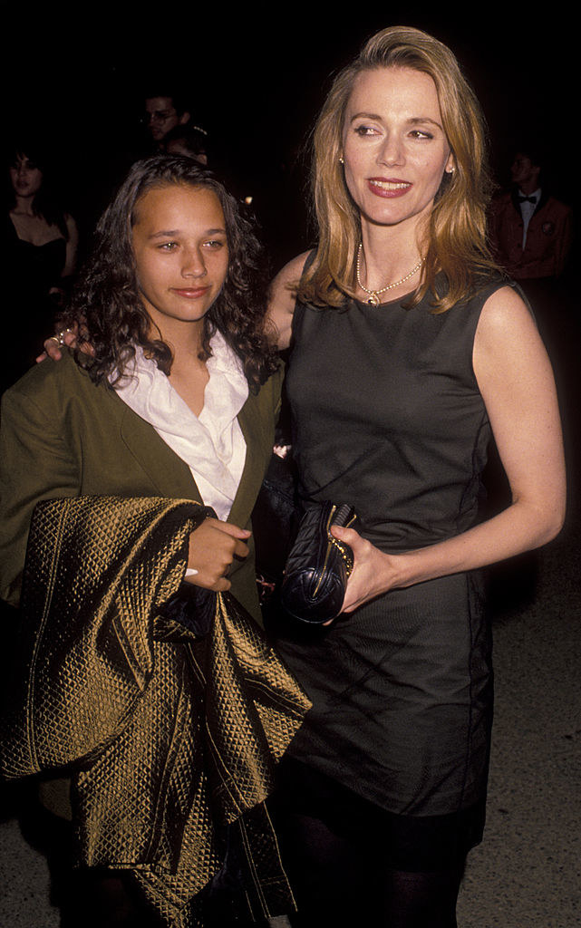 Rashida Jones and her mother, Peggy Lipton, at the Emmy Awards in September 1990; Rashida Jones with shoulder-length curly hair and wearing a suit/blazer
