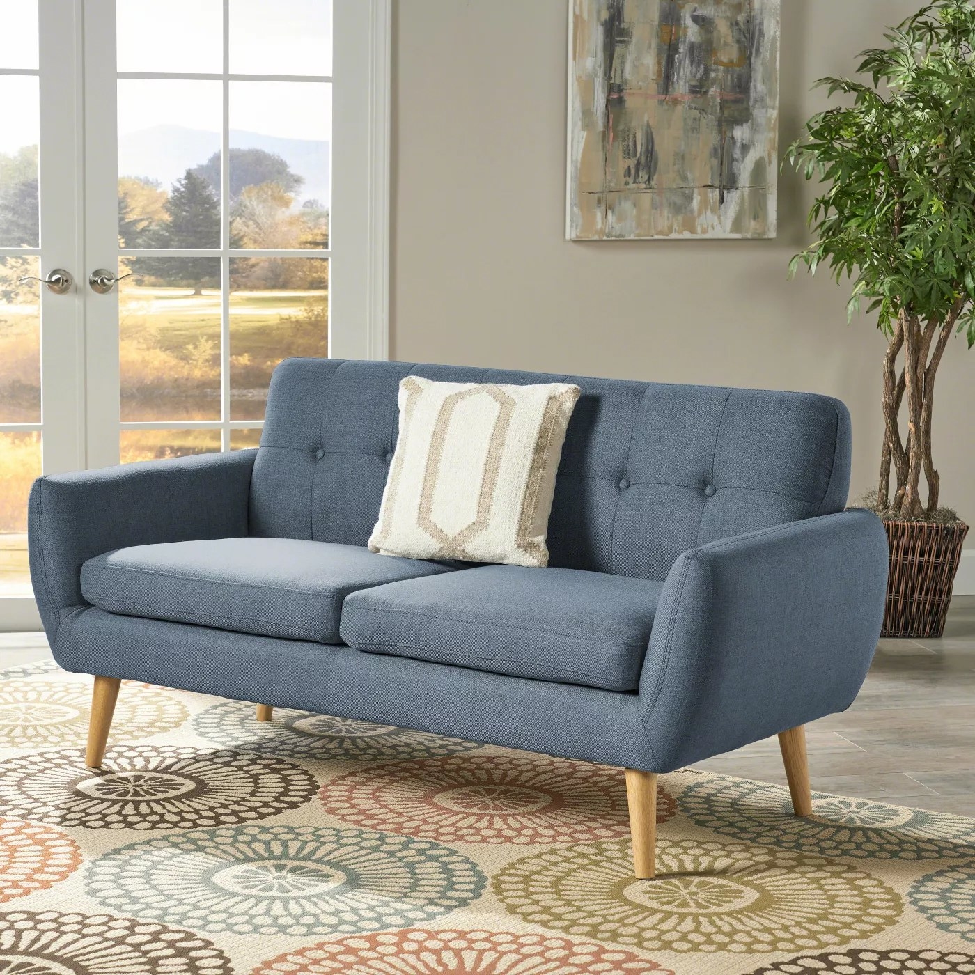 The blue sofa with wooden legs