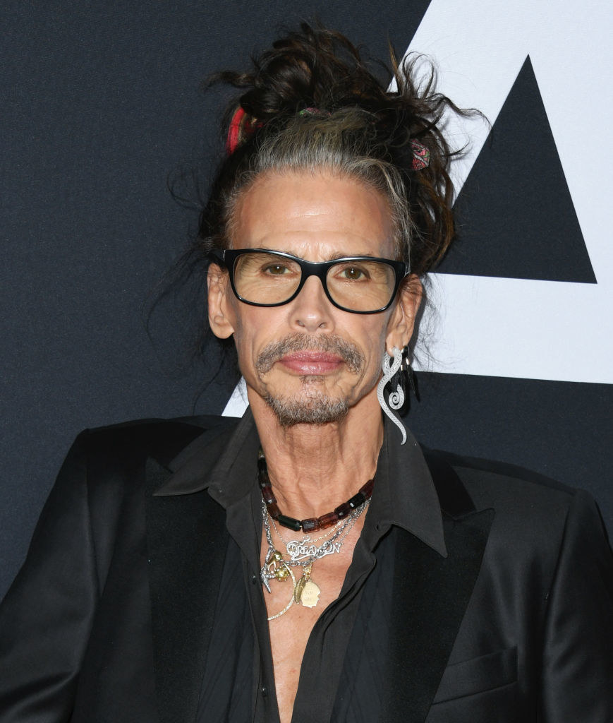 Steven Tyler at the premiere for "Ad Astra" in 2019, wearing multiple necklaces and a man