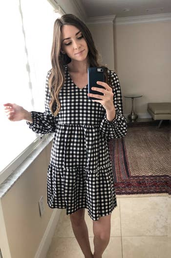 reviewer wearing the black and white gingham dress