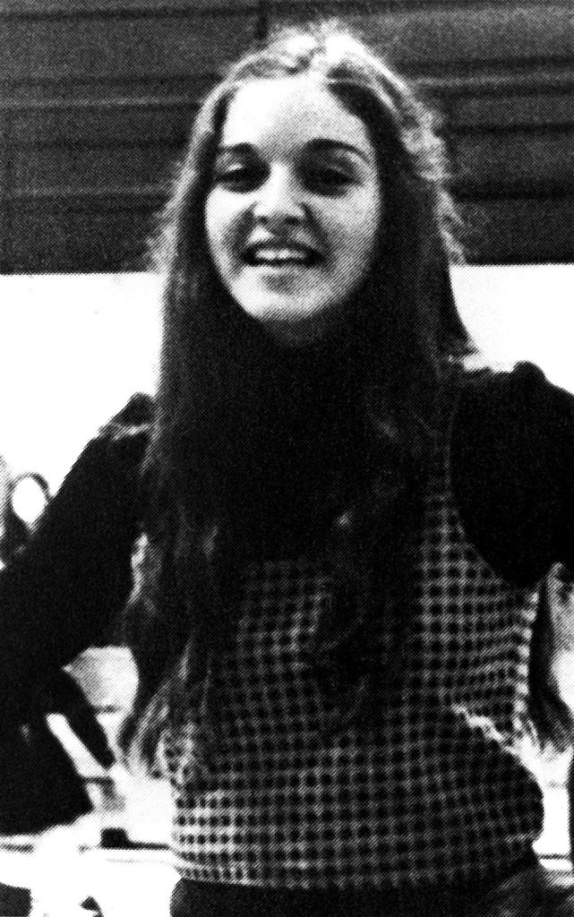 Madonna practicing cheers with long, curly hair in 1972