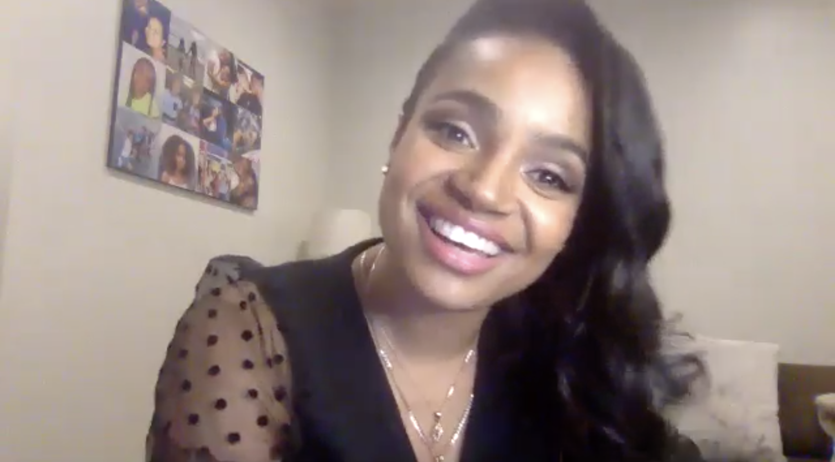 Kyla Pratt smiling with a painting in the background