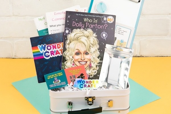 box containing a who is dolly parton book and other activities 