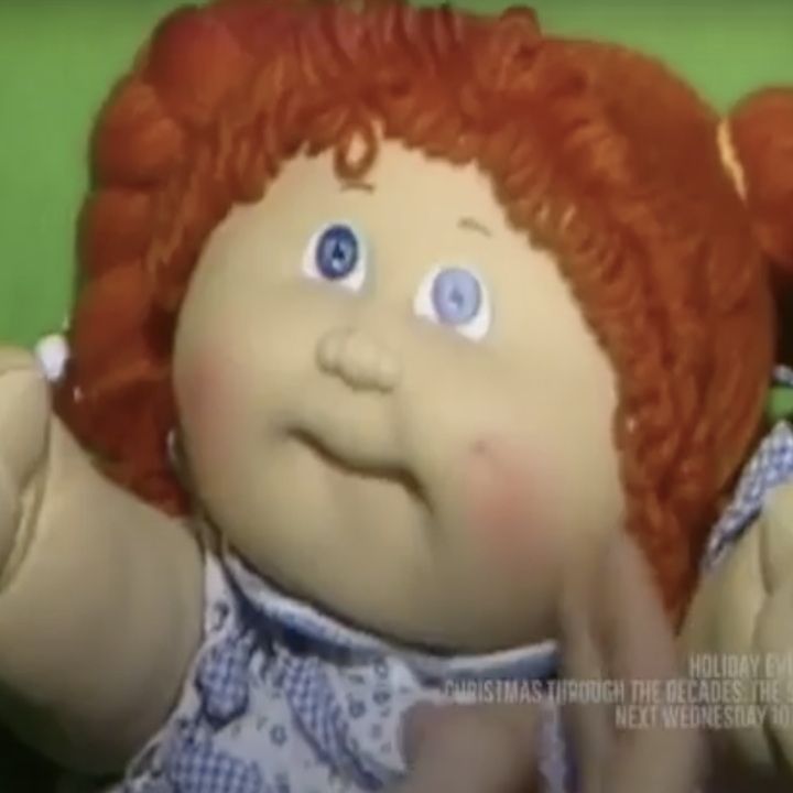 A close-up of a Cabbage Patch Kid with orange hair
