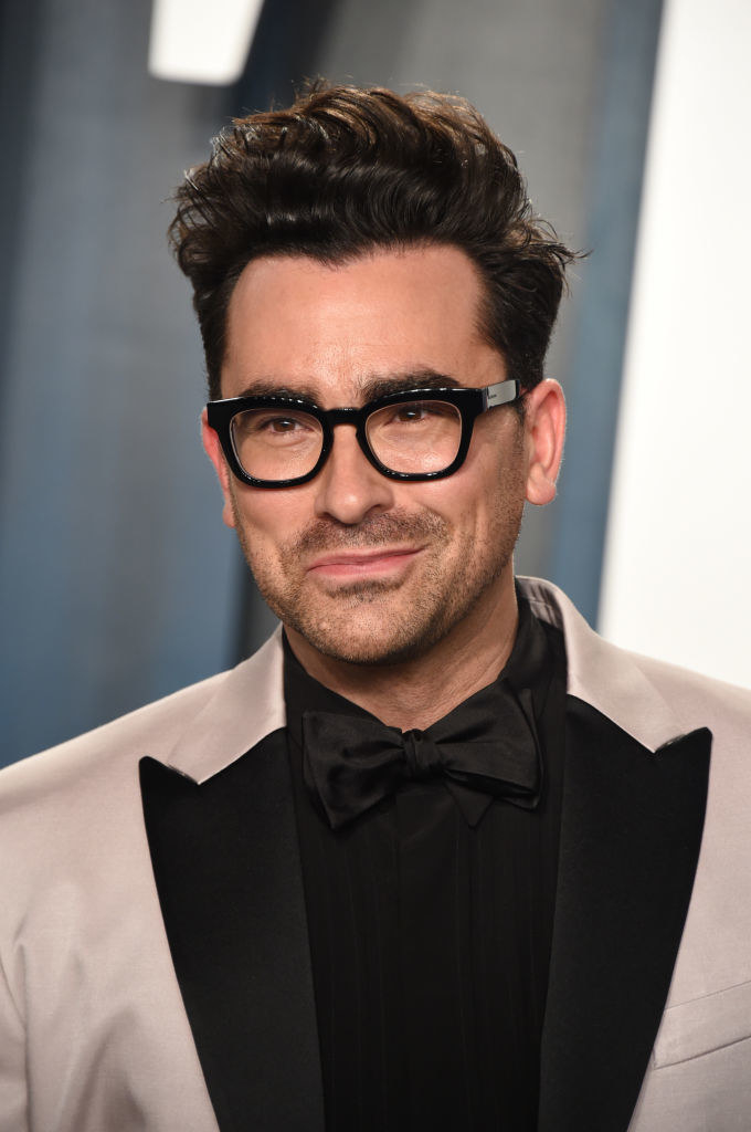 Dan Levy happily smiling on the 2020 Vanity Fair Oscar Party red carpet 