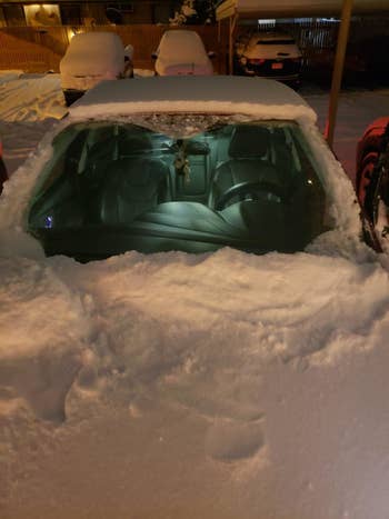 The car without the cover on revealing a completely snow-free windshield