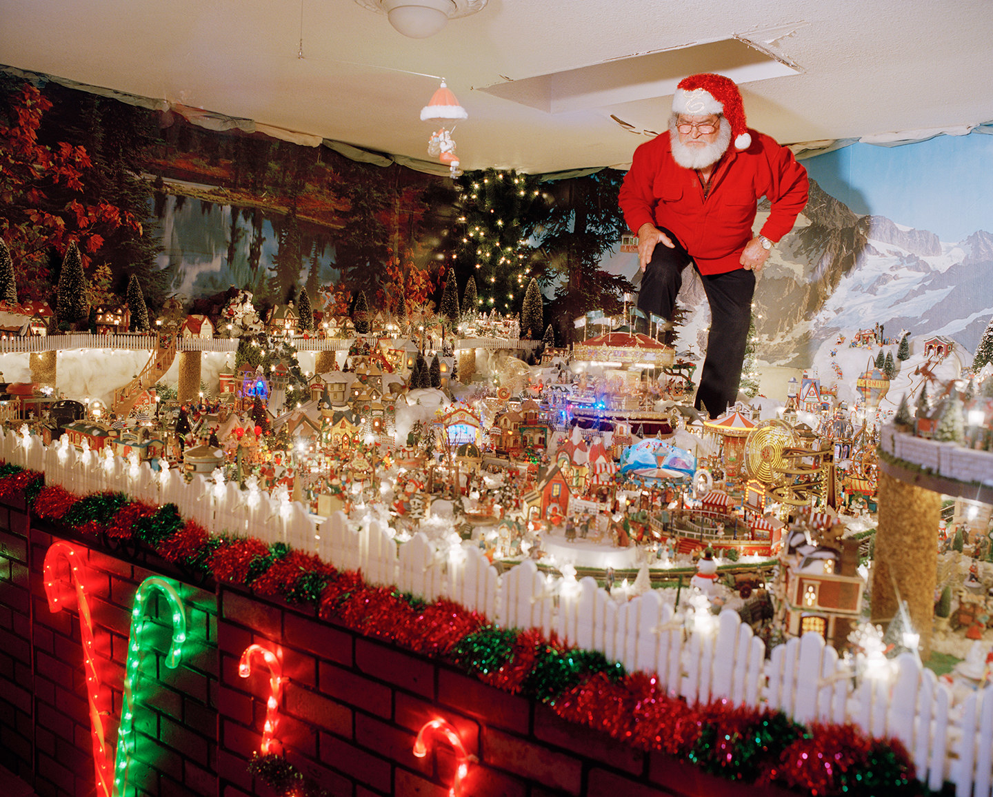 A man standing in a giant Christmas train display