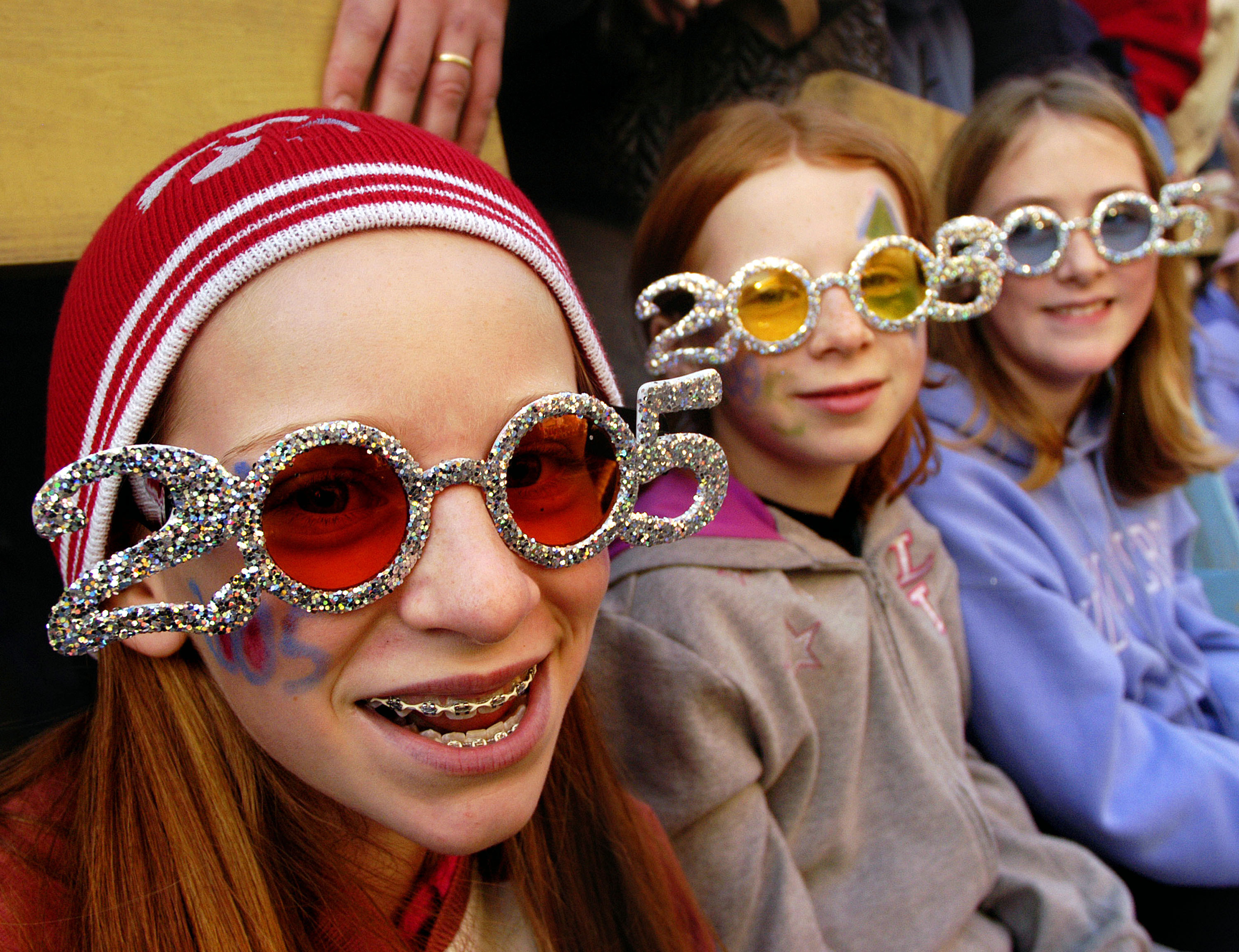 Three teen girl wearing 2005 New Years glasses
