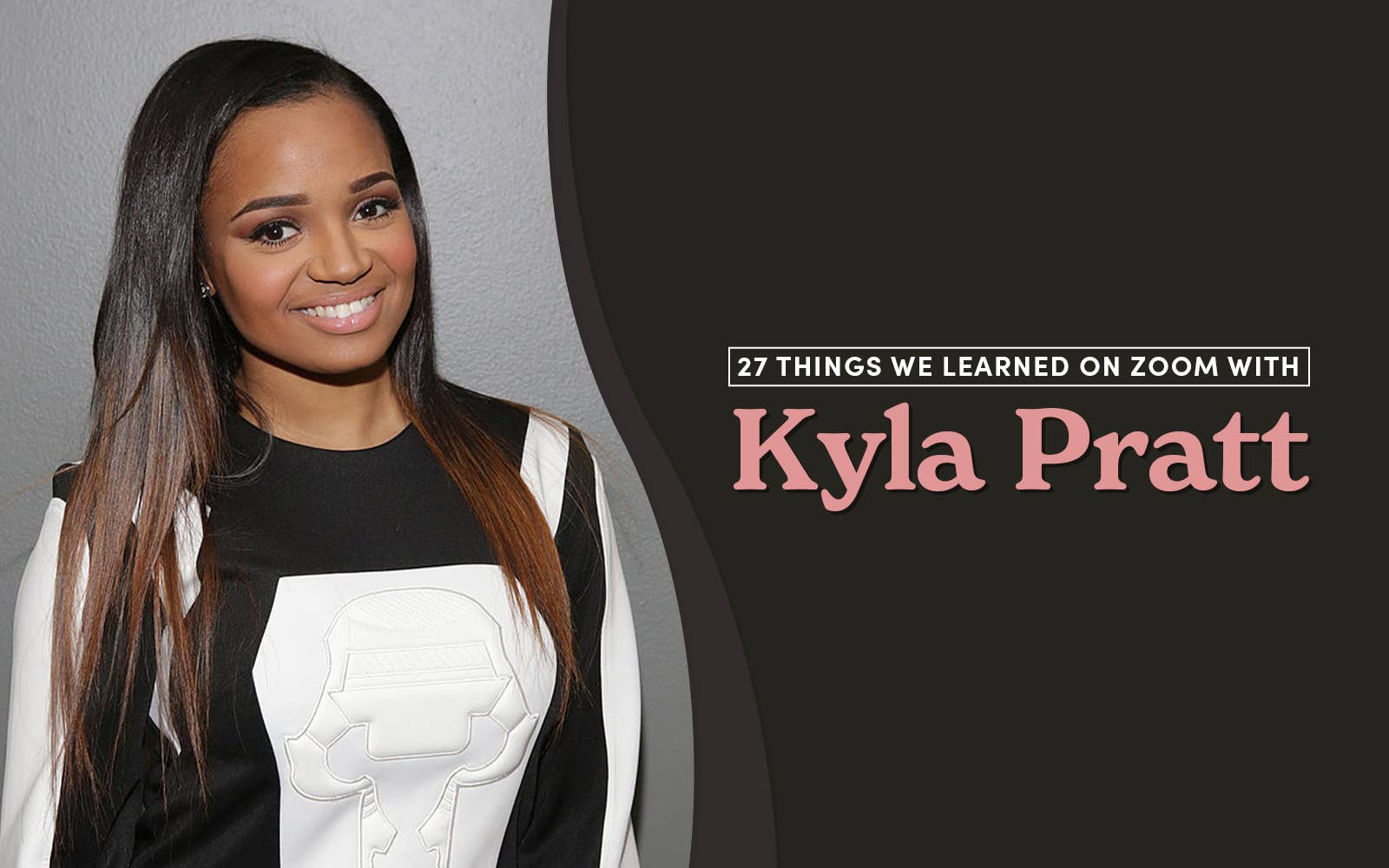 Kyla Pratt smiling, wearing a dark and light outfit with bright lipstick
