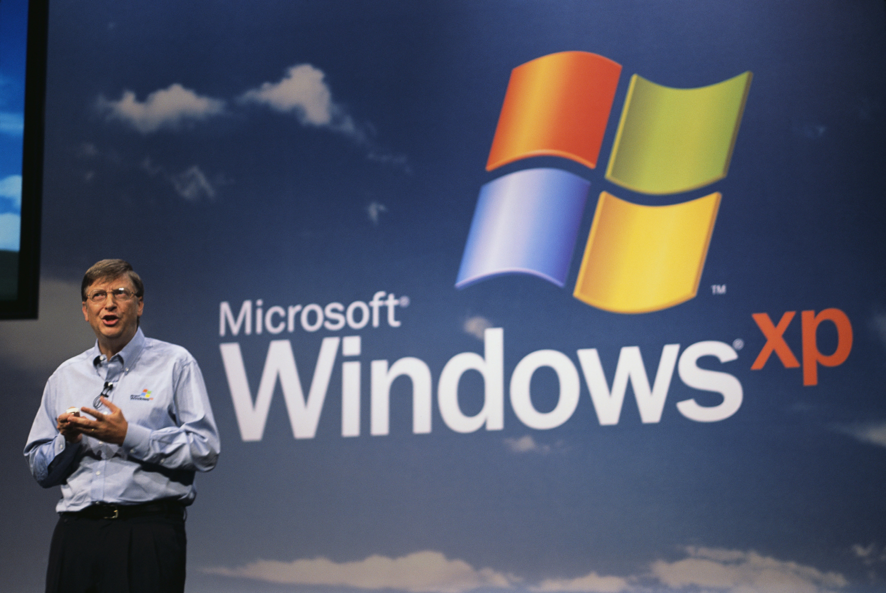 Bill Gates speaking on stage at the launch of Windows XP.