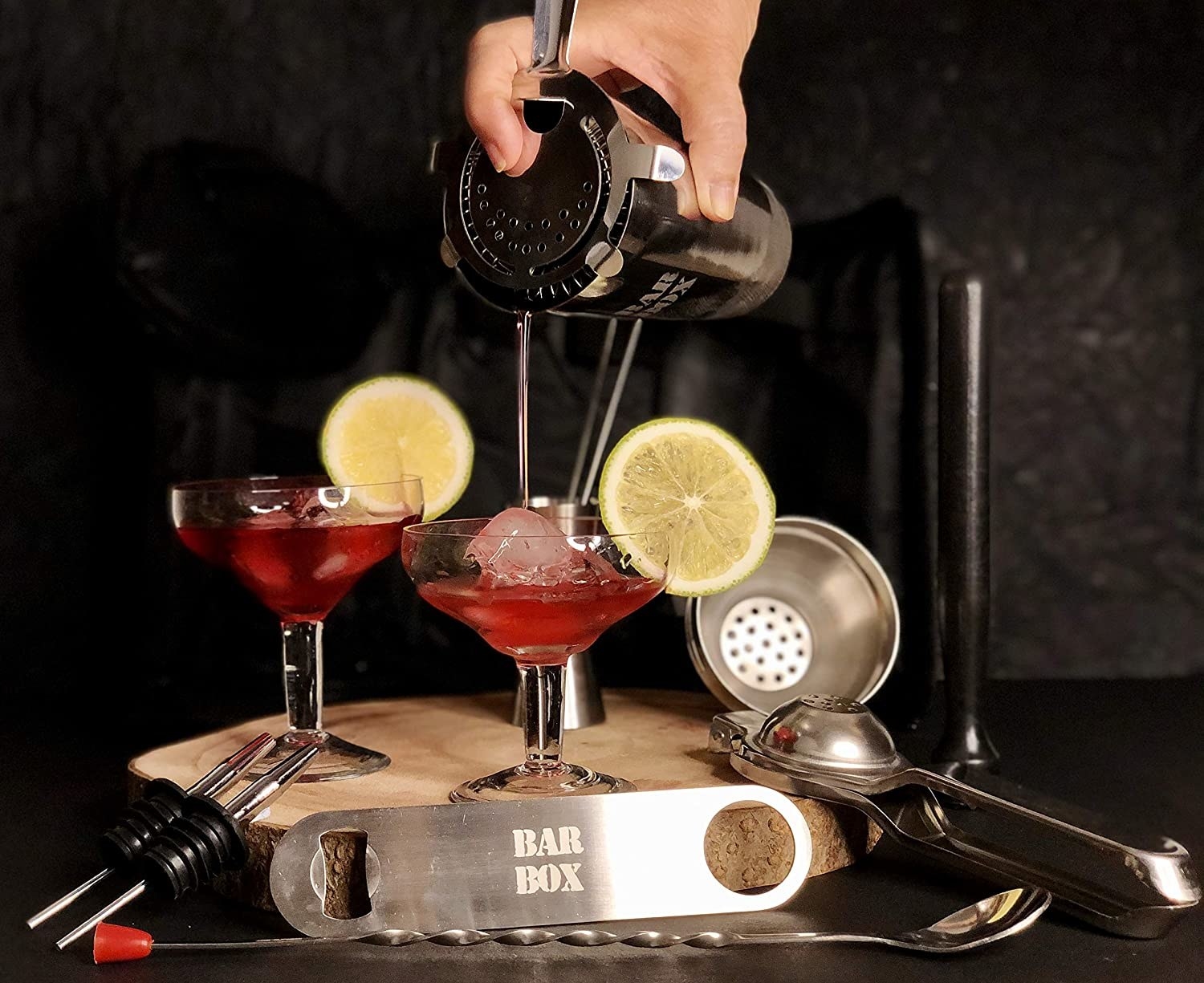 A person pouring a cocktail.