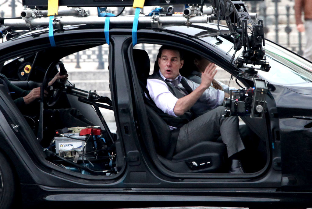 Tom Cruise filming in a car on the set of Mission: Impossible 7