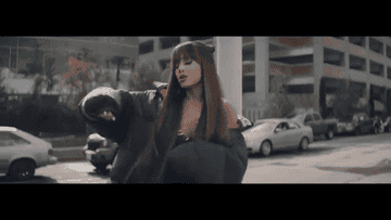 Ariana Grande dancing in an oversized puffer jacket in the &quot;Everyday&quot; music video
