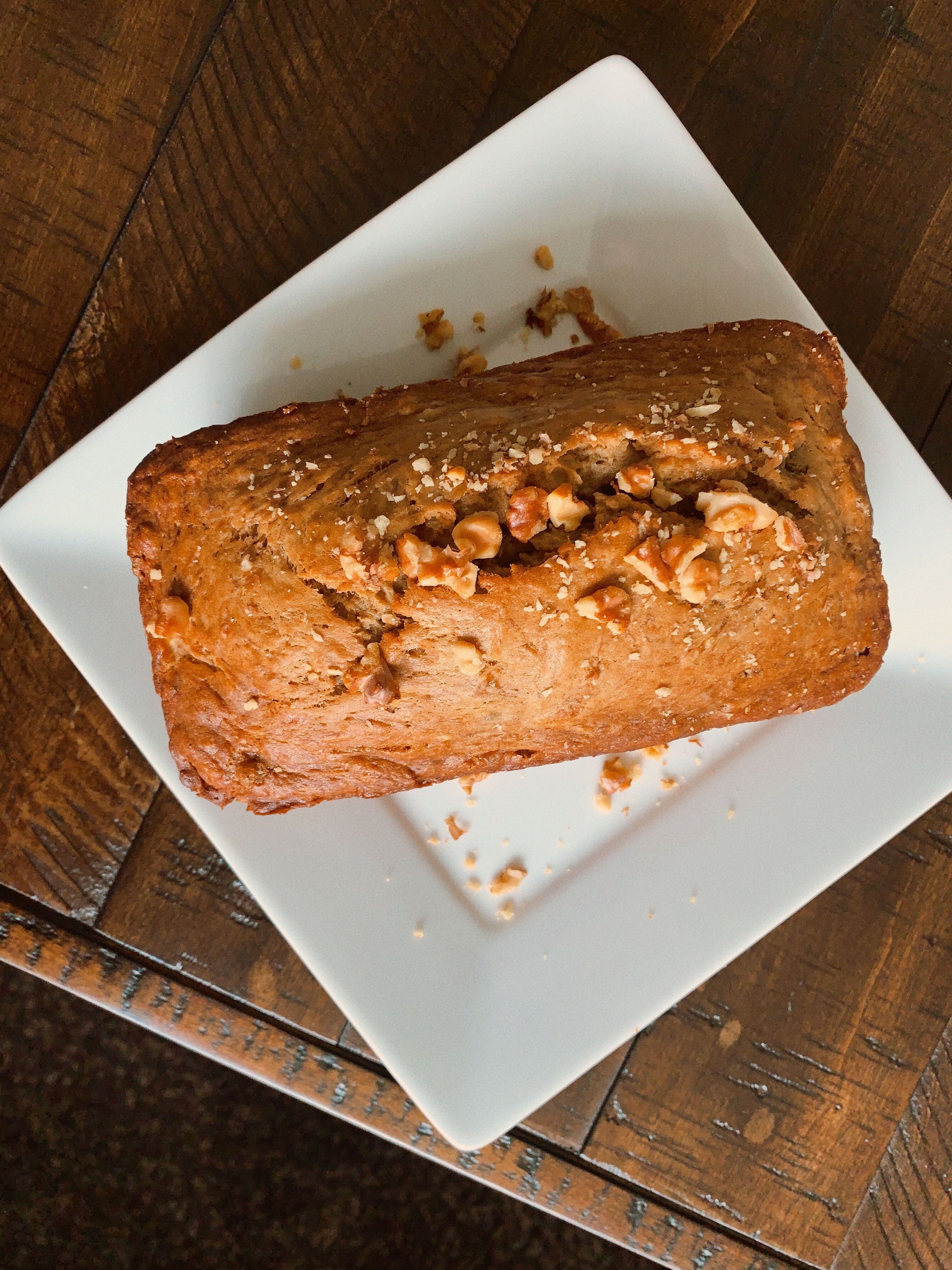 a loaf of banana bread sprinkled with walnuts