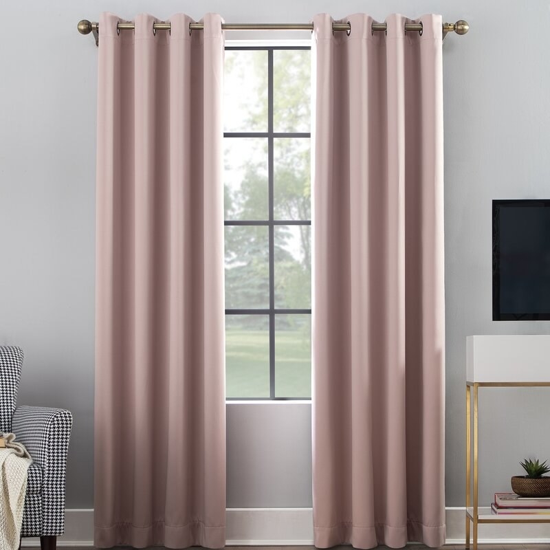 The curtain panels in blush, which reach the floor and have grommets for hanging