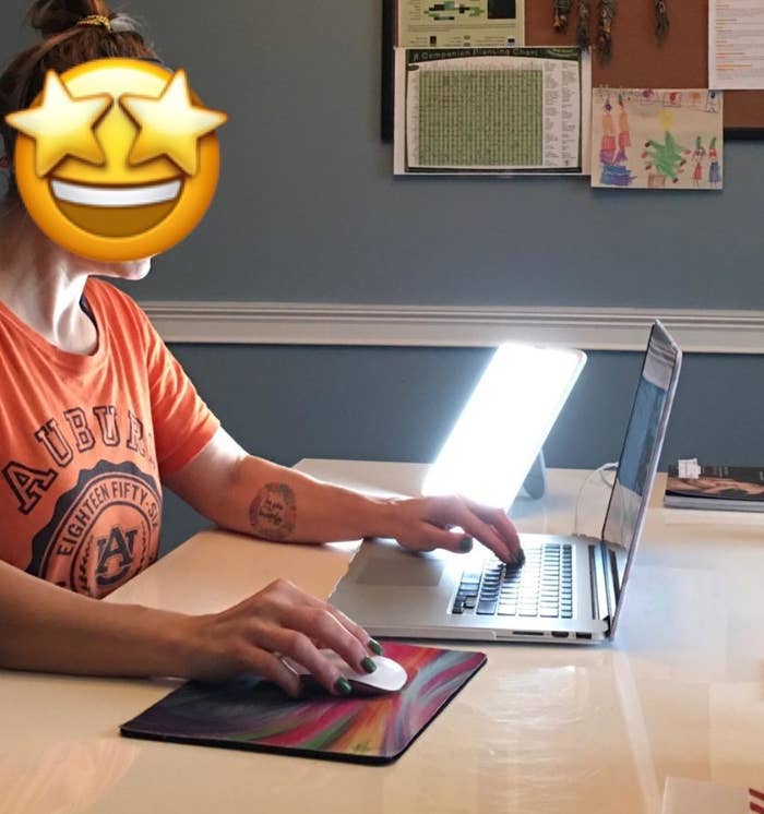 reviewer photo showing the therapy light next to a person working at their laptop 