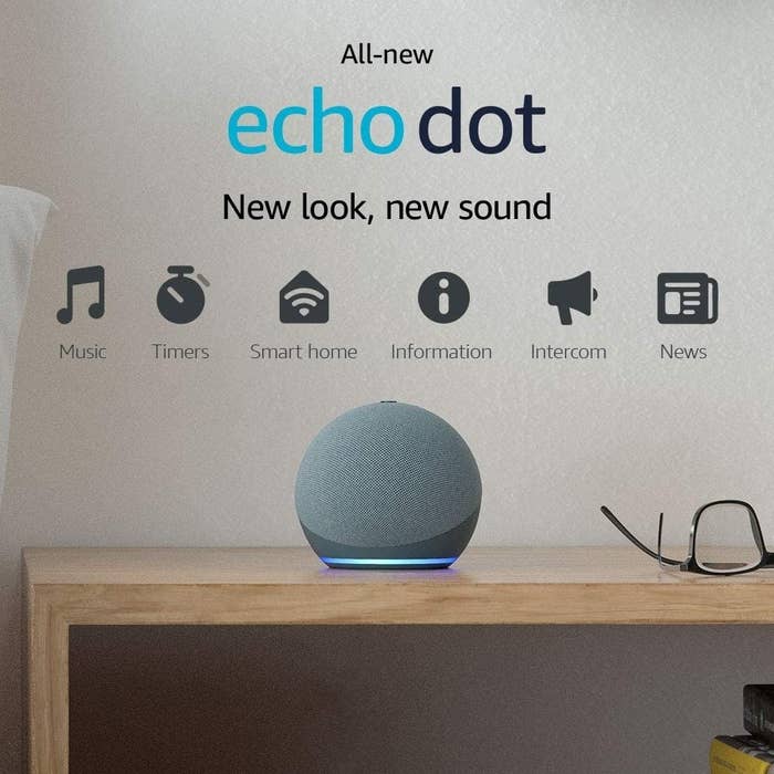 the echo dot in chrome blue sitting on a desk 