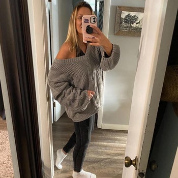 Reviewer wearing Astylish cable-knit sweater in the shade gray