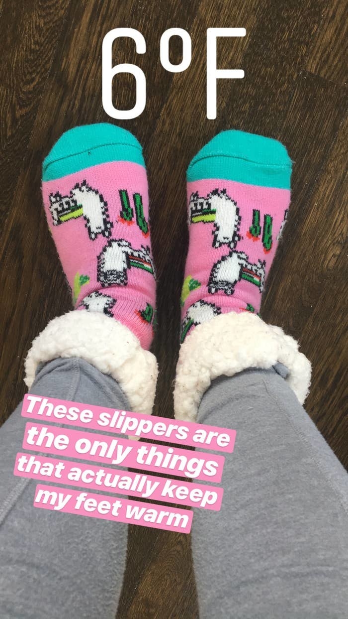 Maitland wearing the socks with overlay text that reads &quot;These are the only things that actually keep my feet warm&quot;