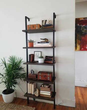 A reviewer's photo of the bookshelf in warm walnut and black