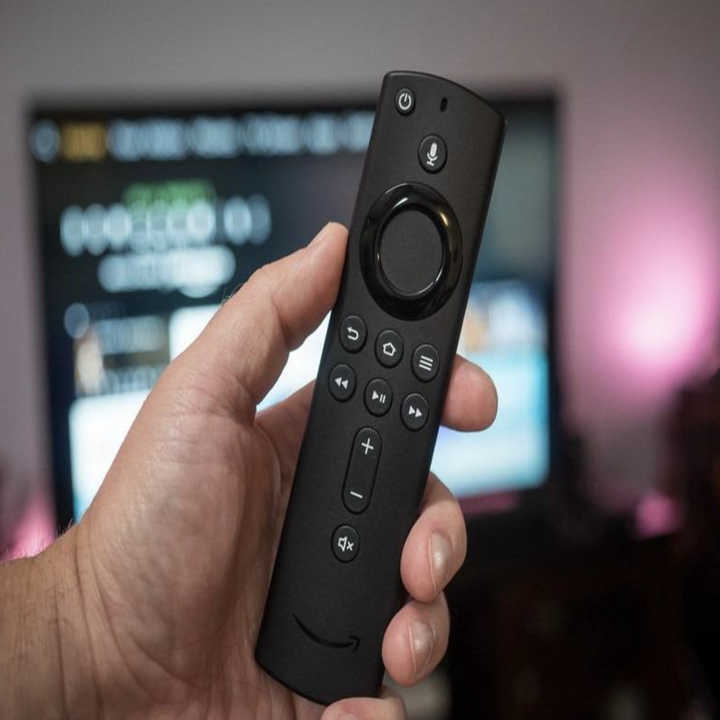 reviewer holding fire stick remote