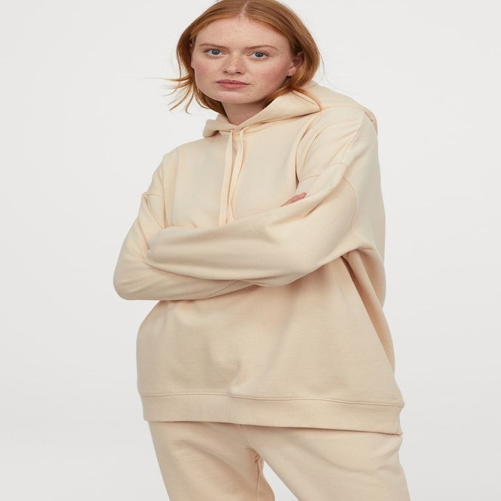 Model wearing light beige H&amp;M oversized cotton hoodie