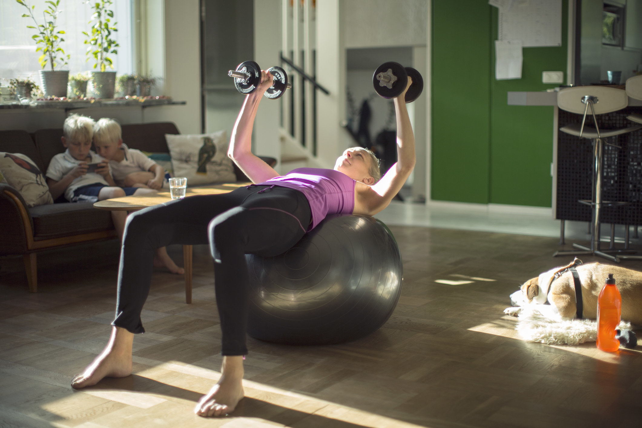 A person using exercise equipment at home in their living room