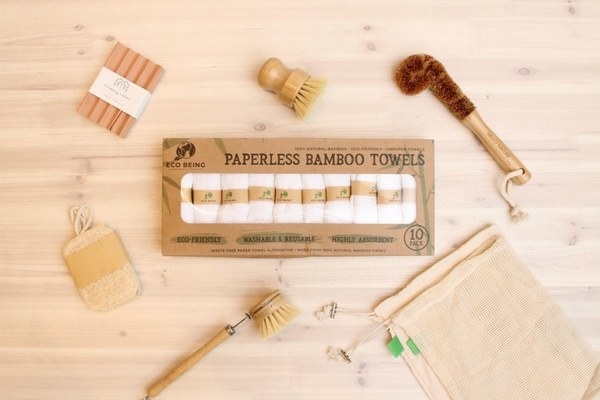 three bamboo scrub brushes, a pack of bamboo towels, a scouring pad and reusable bags