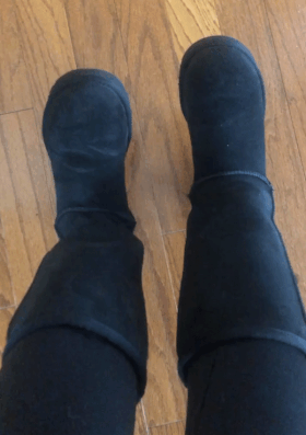 buzzfeed editor tapping their feet while wearing tall black uggs