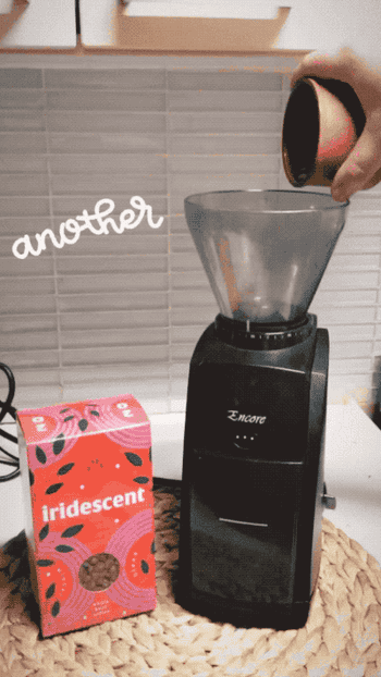 A gif of someone pouring coffee into the burr grinder