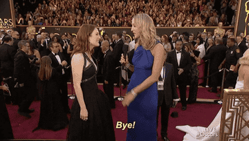 Julian Moore and presenter waving goodbye on the Oscars red carpet