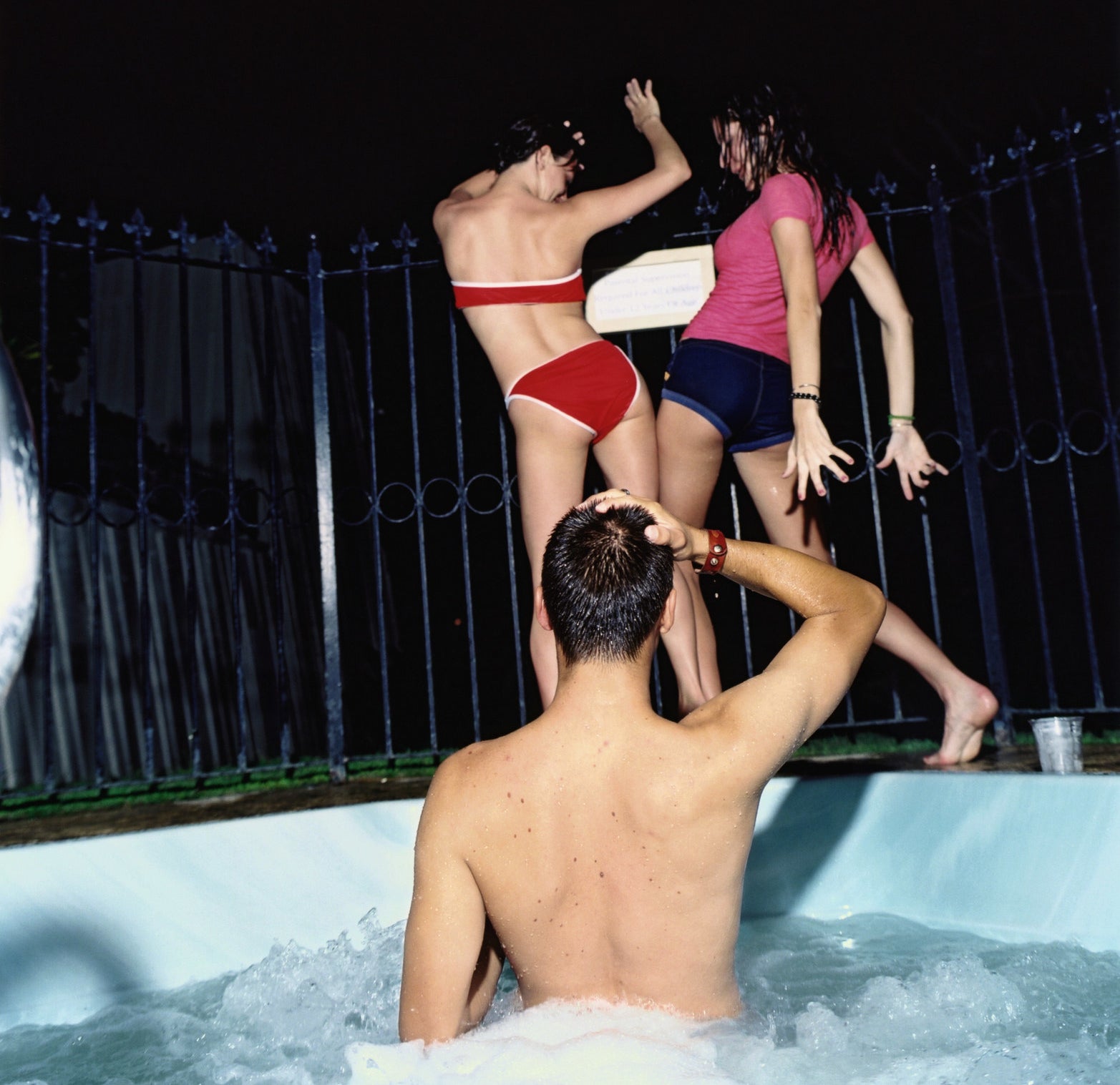 Three people partying in a hot tub
