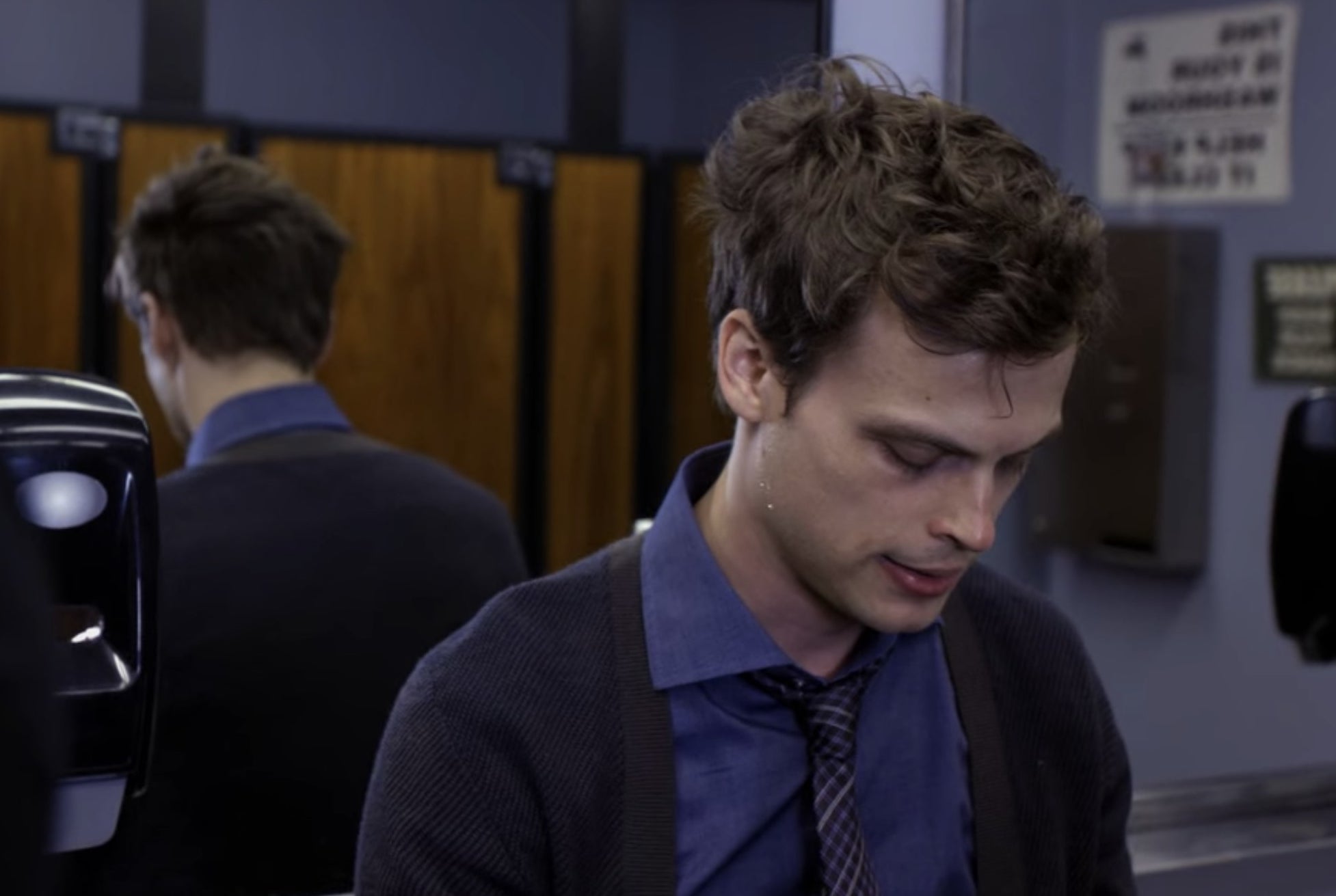 Spencer Reid from Criminal Minds talking in a bathroom