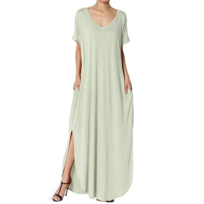 model wears light sage green maxi dress with side slits 