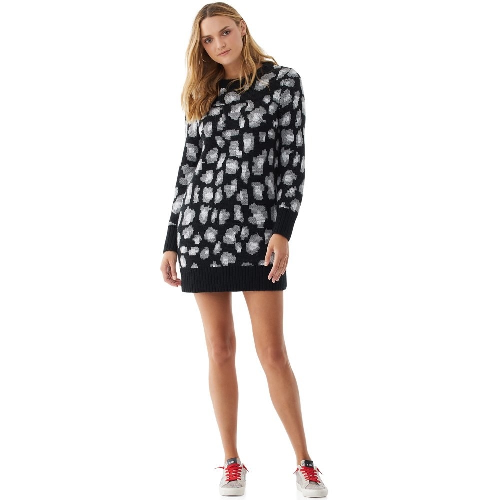 model wears leopard print sweater dress with sneakers 