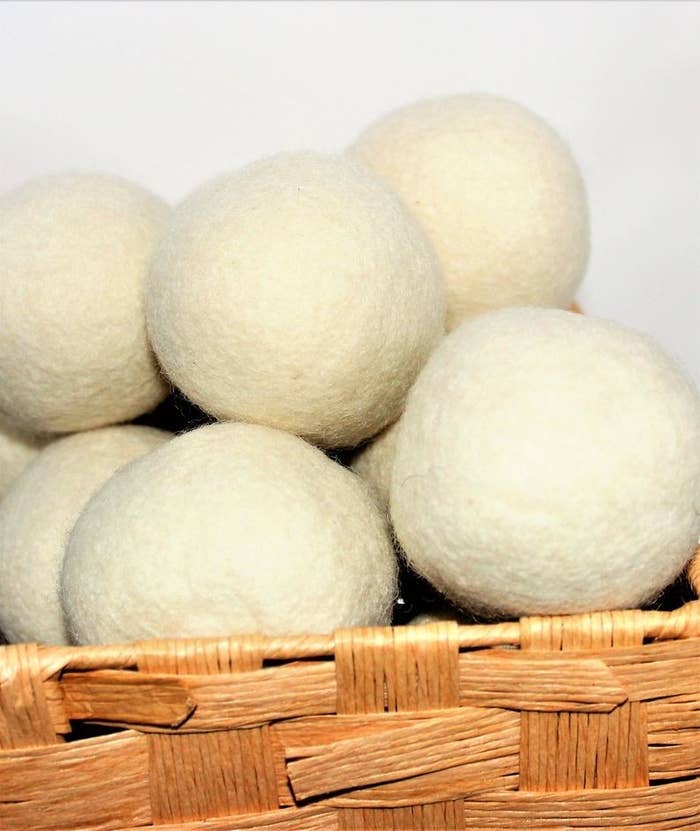 nine wool dyer balls in a basket 