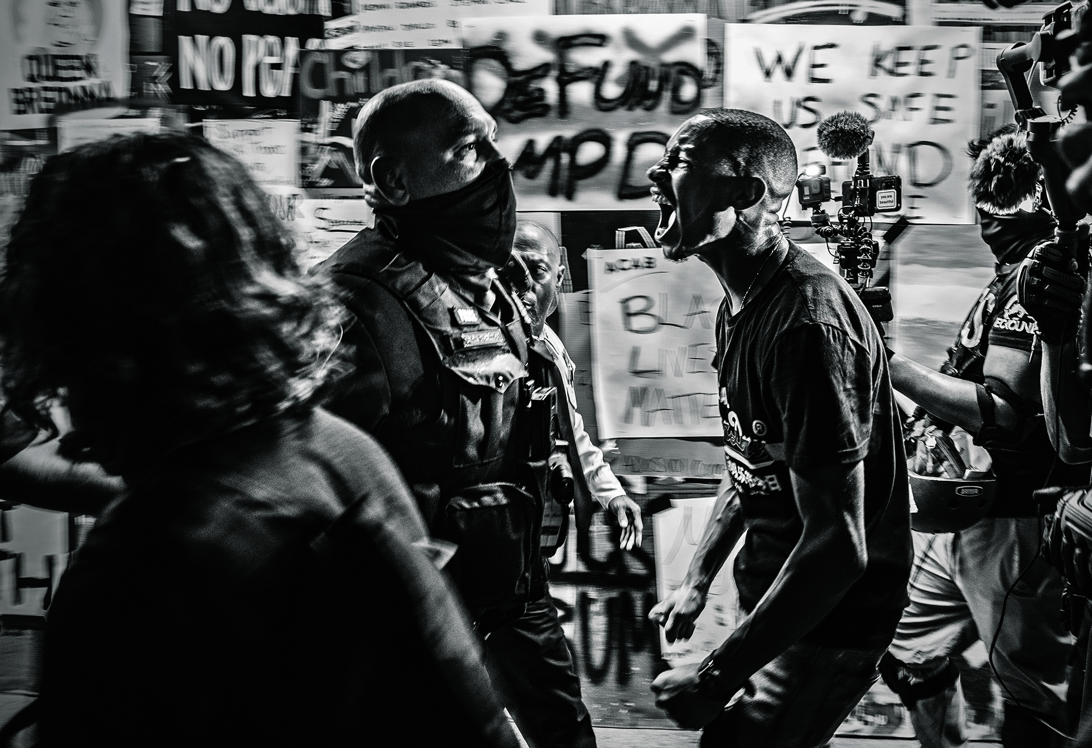 A man yells at a police officer during a protest