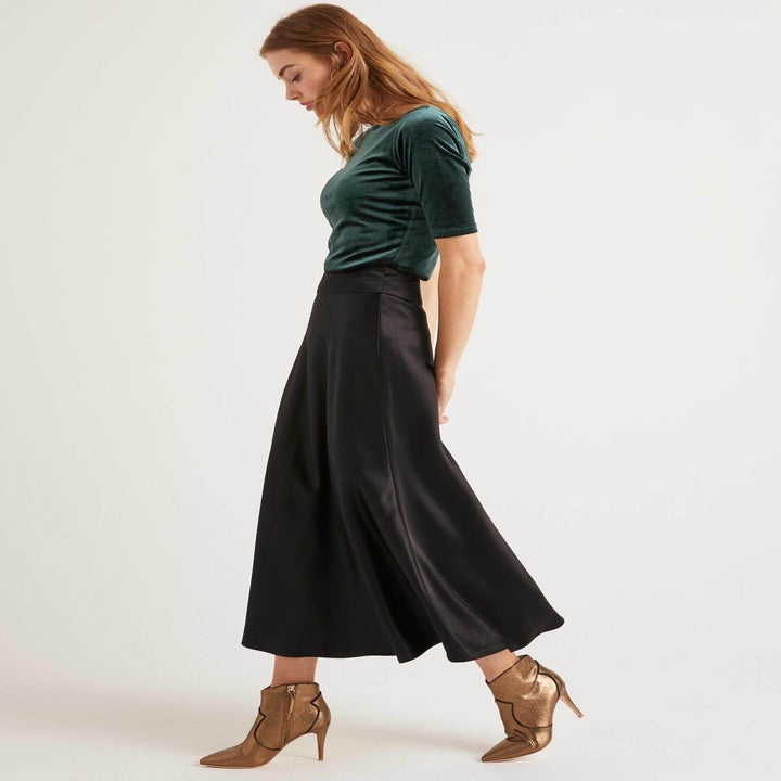 Model in black ankle length high waist skirt 