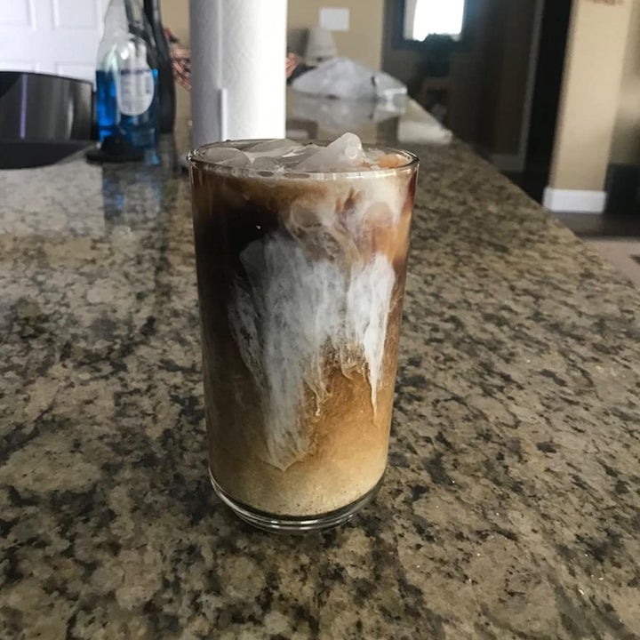 reviewer photo showing cold brew in a glass with ice and creamer