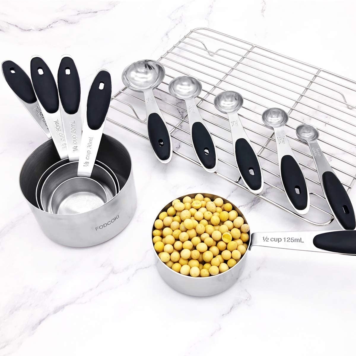 the set of 12 Kitchen Measuring Cups and Spoons on a kitchen counter