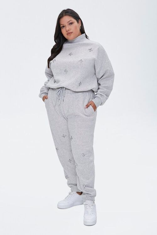 A model in the heathered grey set with multi-stone embellishments scattered on the fabric