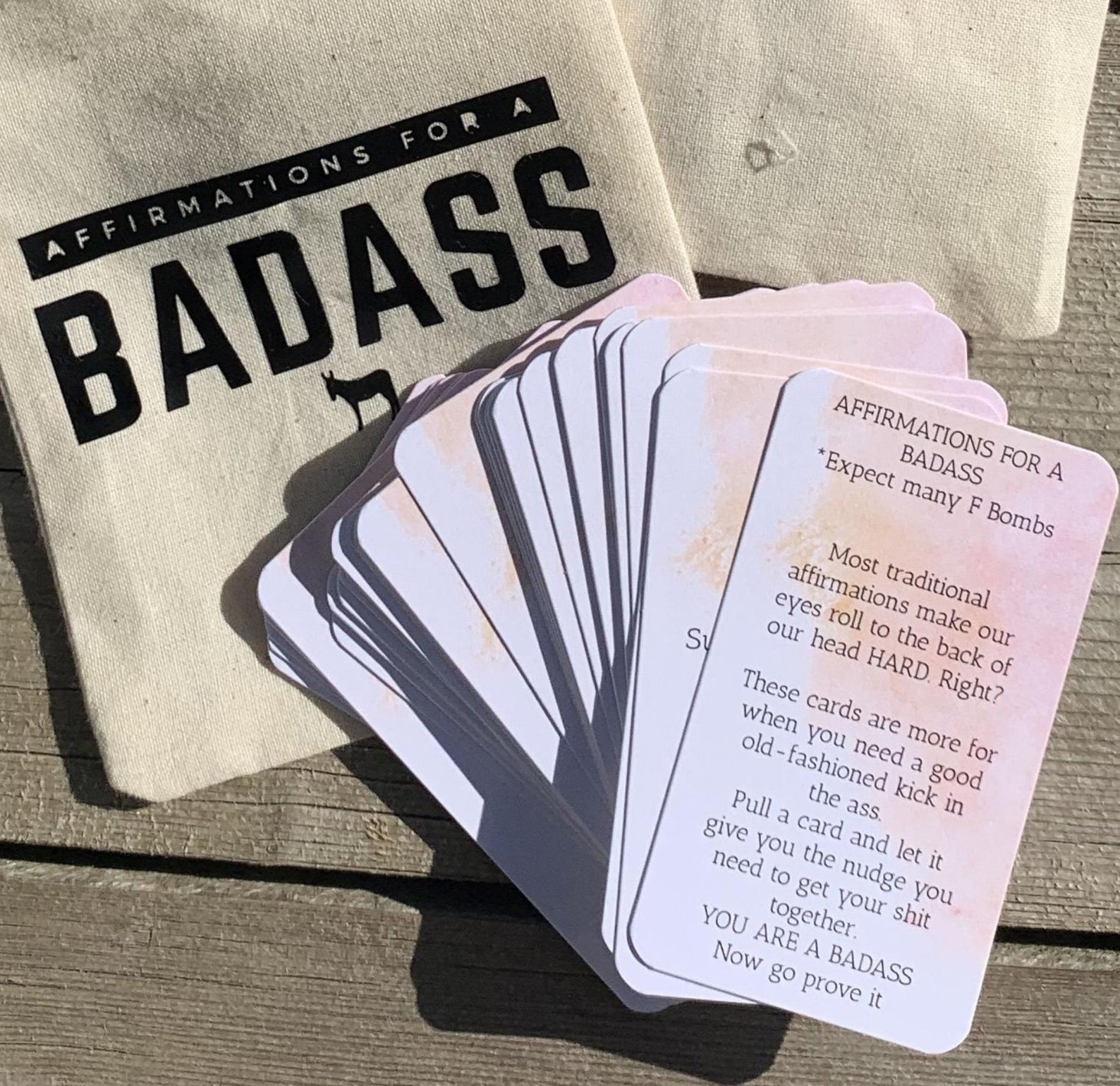 a pack of the cards on a bag that says affirmations for a badass