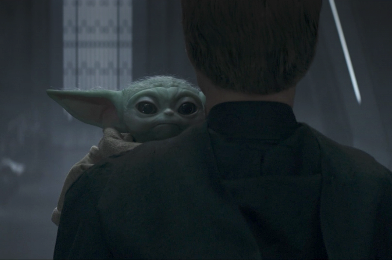 Baby Yoda being carried away